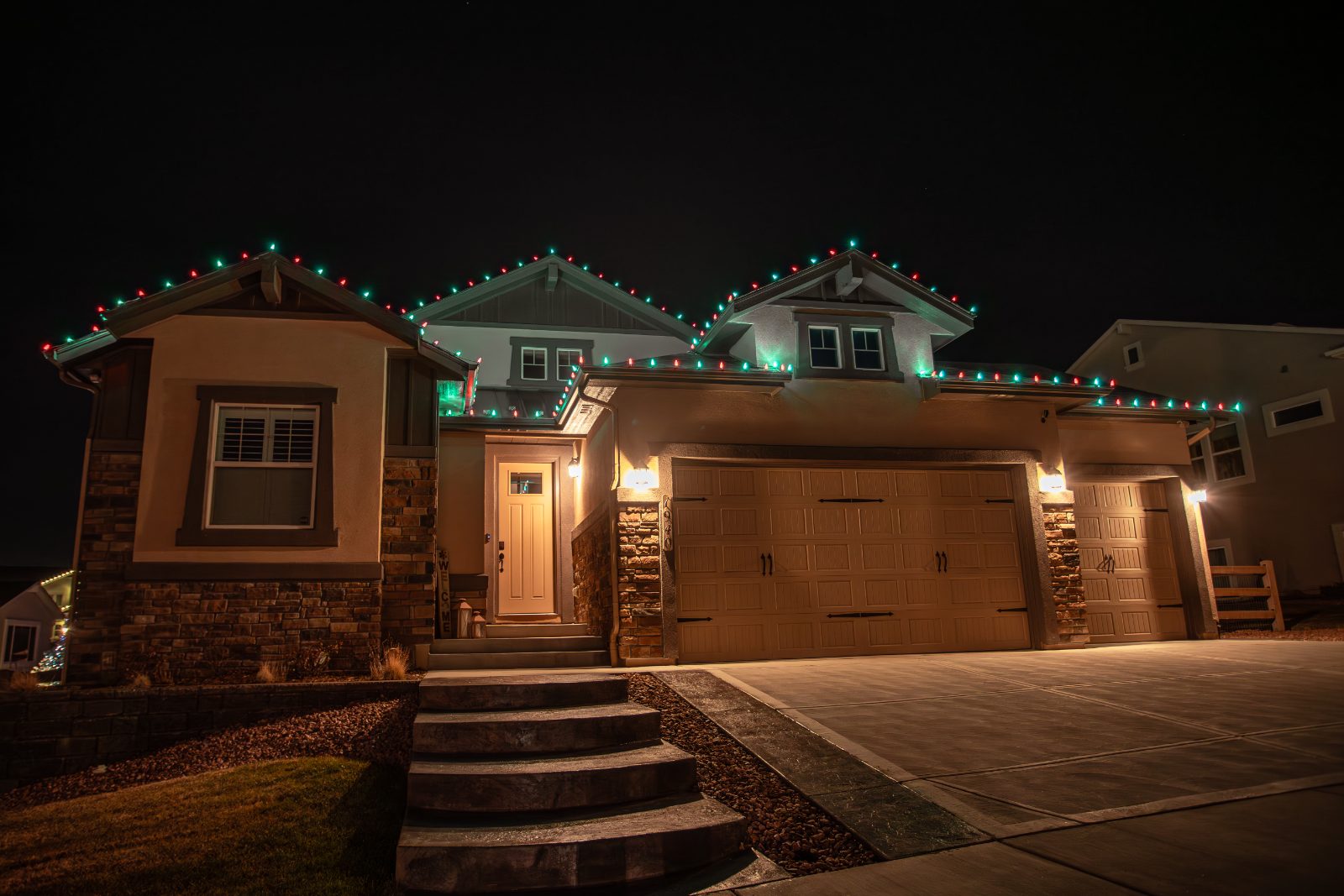 Christmas light installers hanging holiday lights on gutters in Everett, Washington