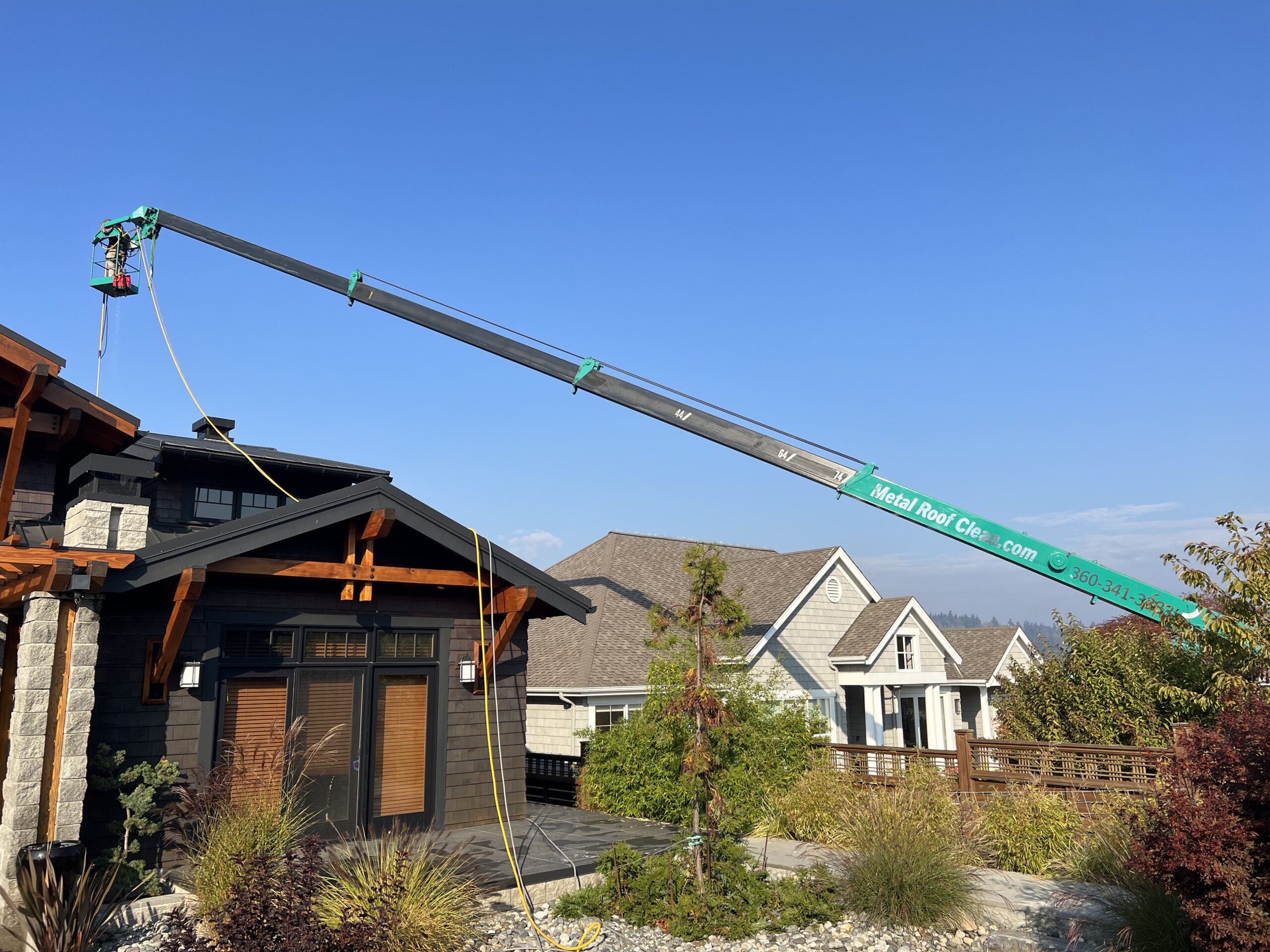 home with a metal roof cleaned by a professional roof cleaning company in Washington